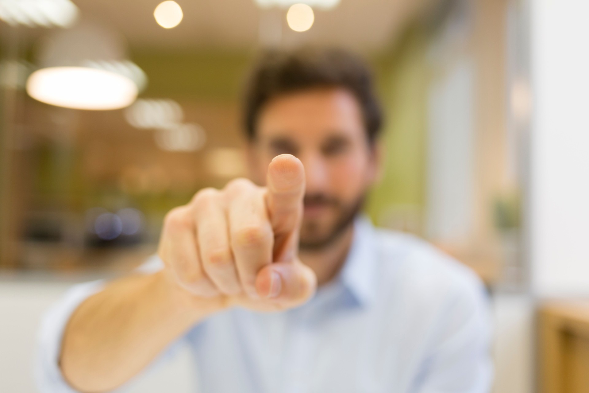 Man hand pushing a digital screen on office background