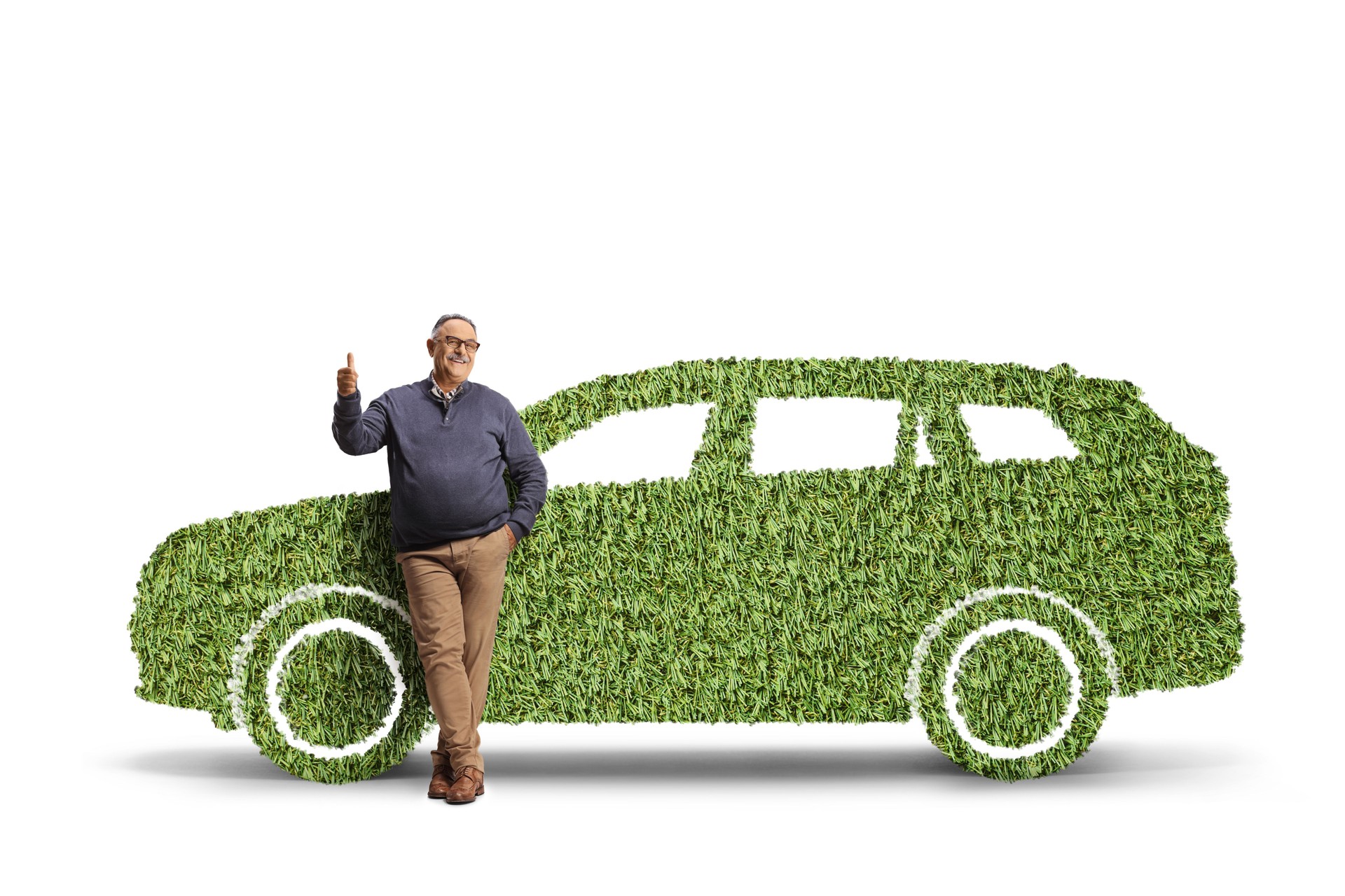 Full length portrait of a mature man leaning on a SUV made of grass and gesturing thumbs up