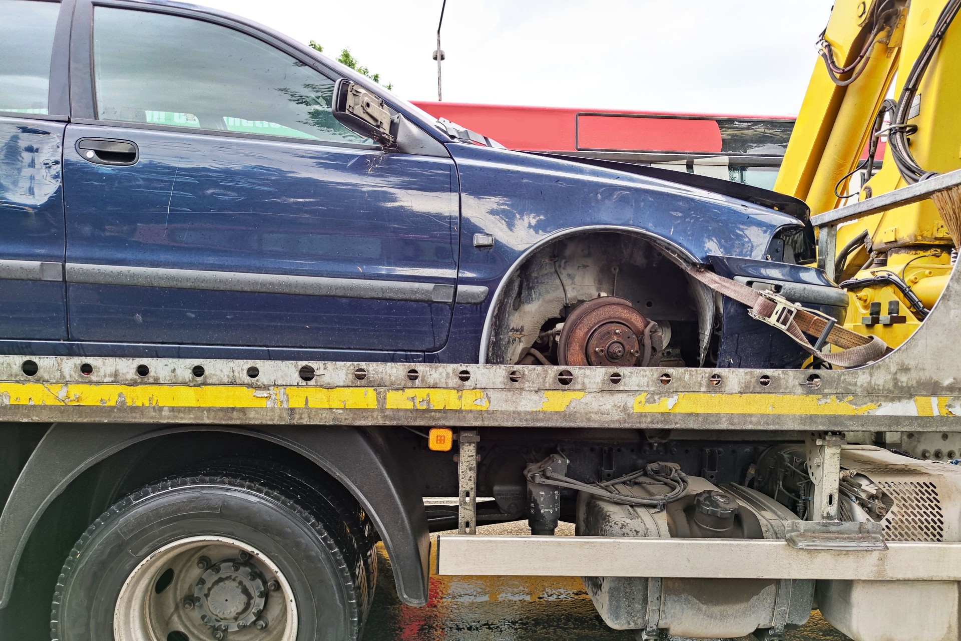 A tow truck carries a car that was wrecked in an accident